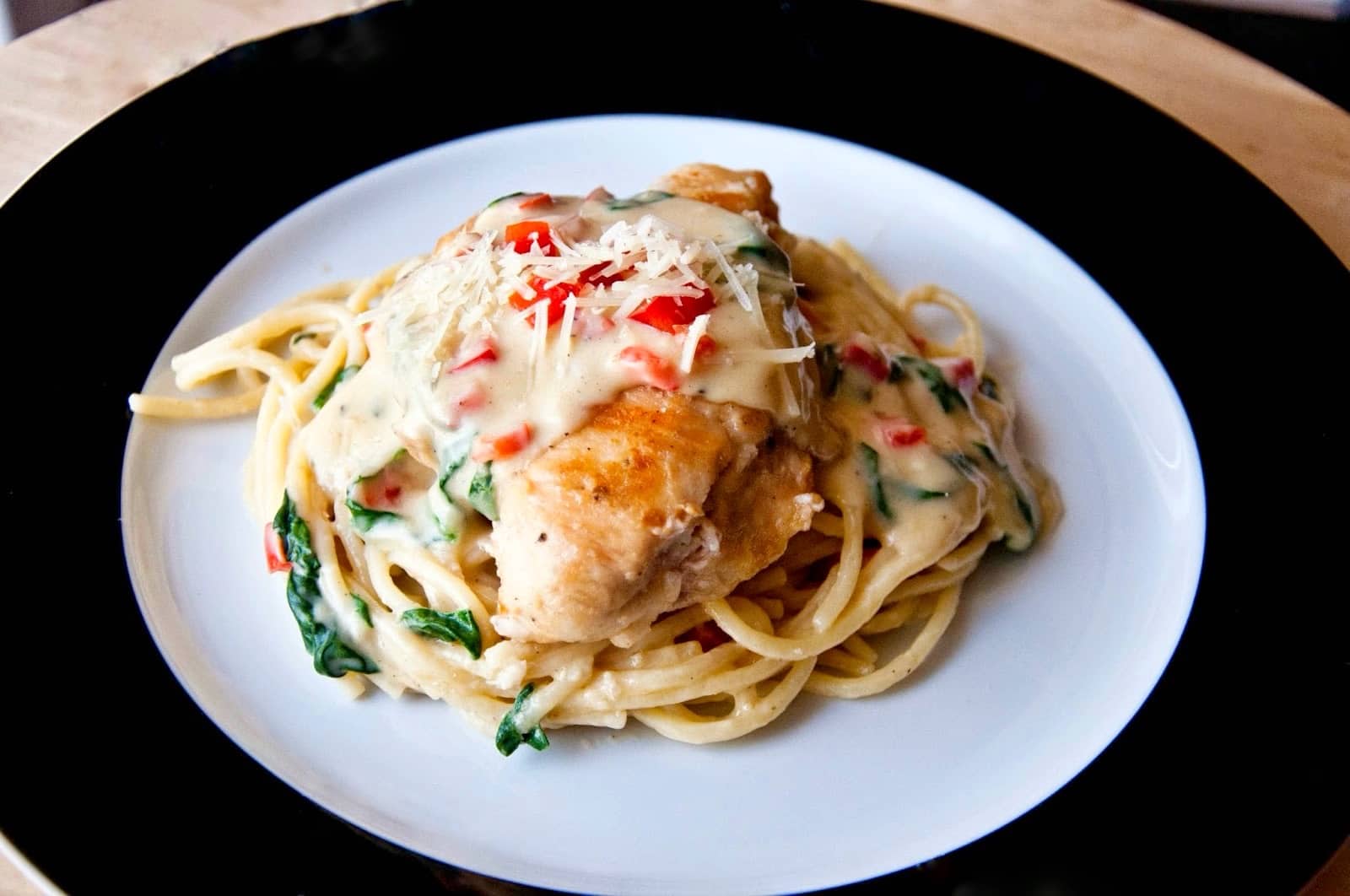 Plated Tuscan chicken with pasta - horizontal.