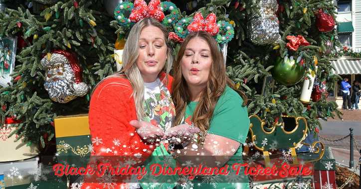 Two women in front of christmas tree blowing snowflakes