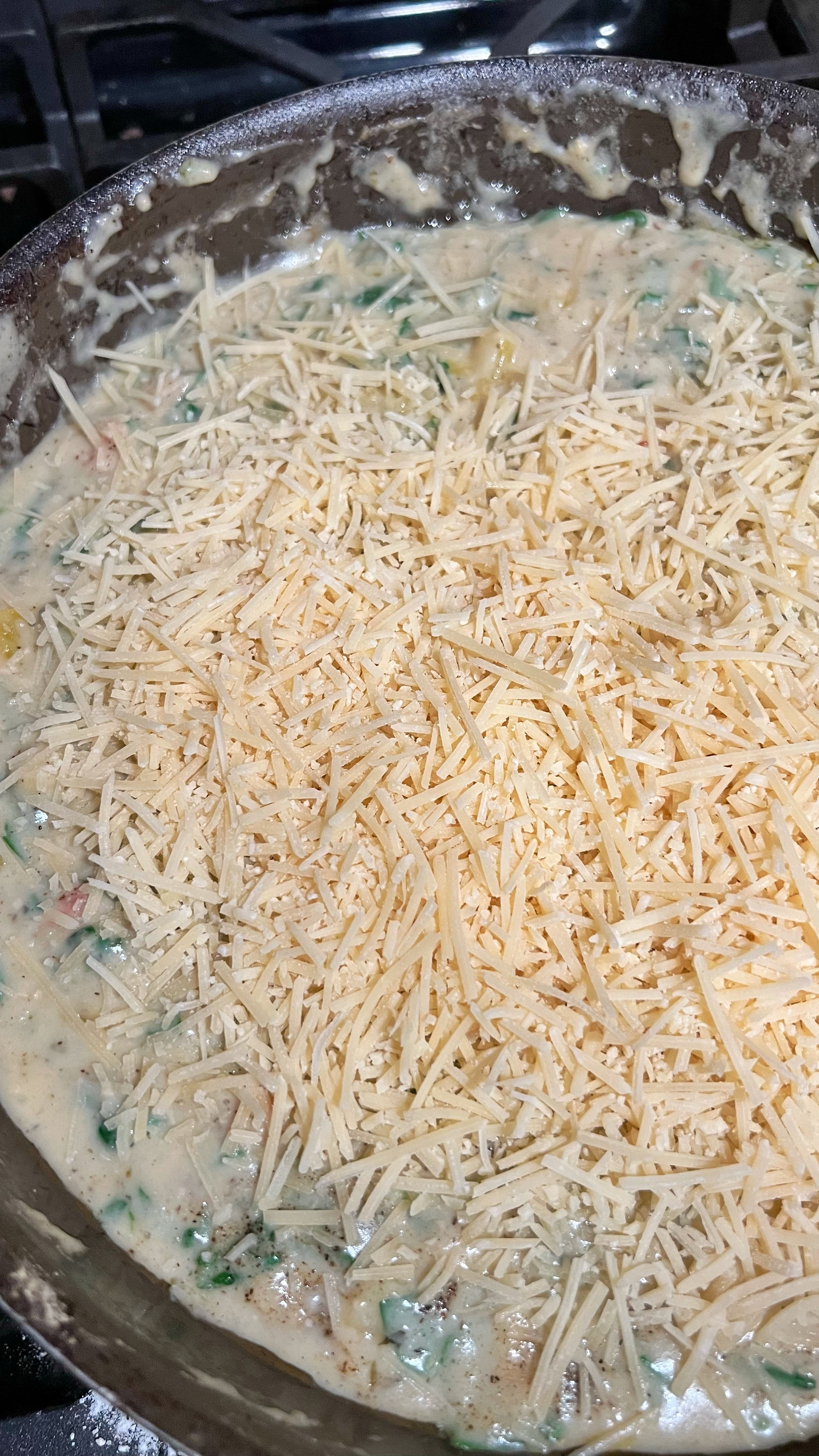 Shredded parmesan cheese added to Tuscan chicken sauce.