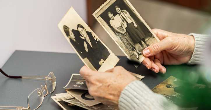 Black and white pictures being held by two hands.