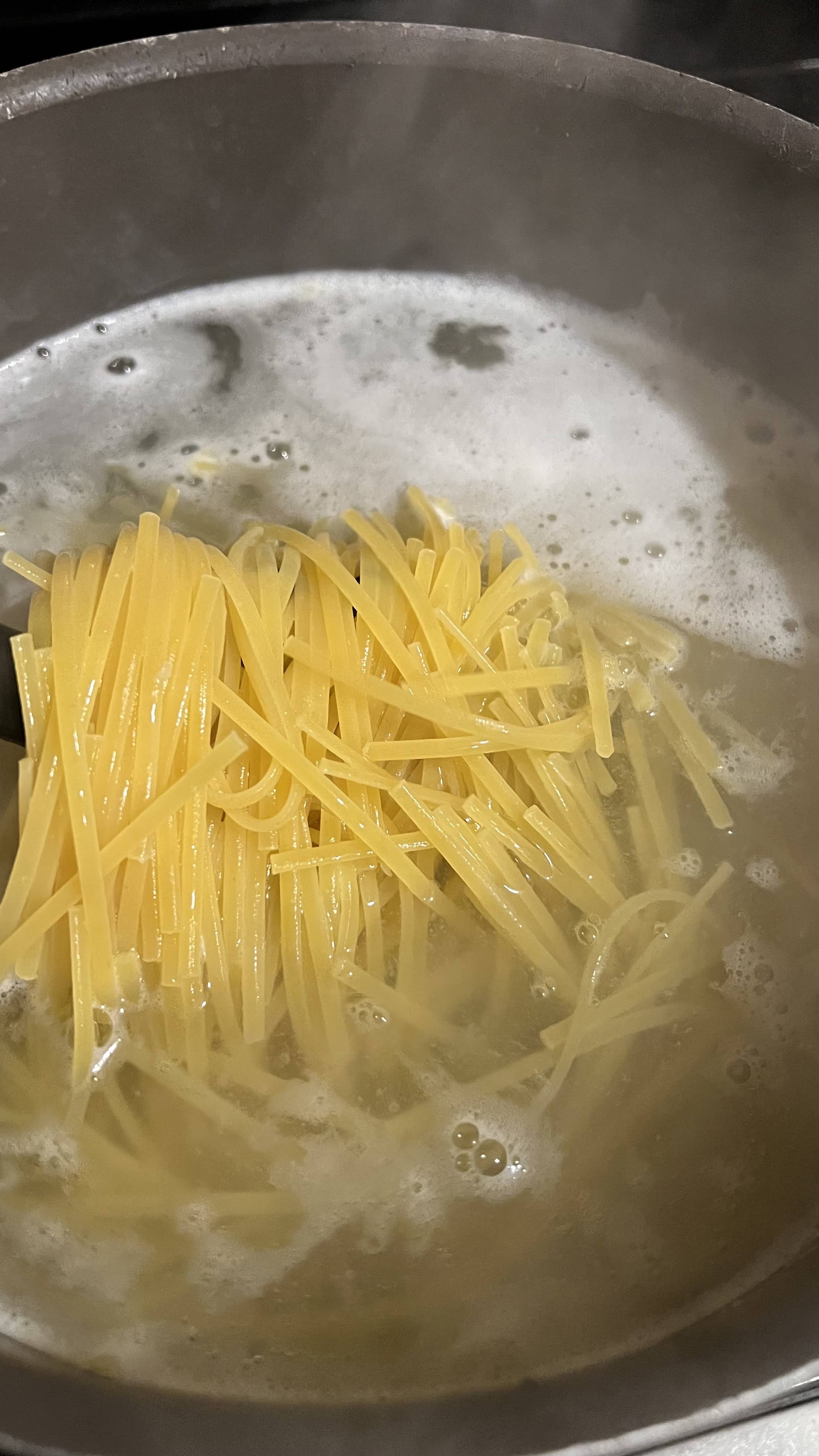 Linguini noodles in boiling water.